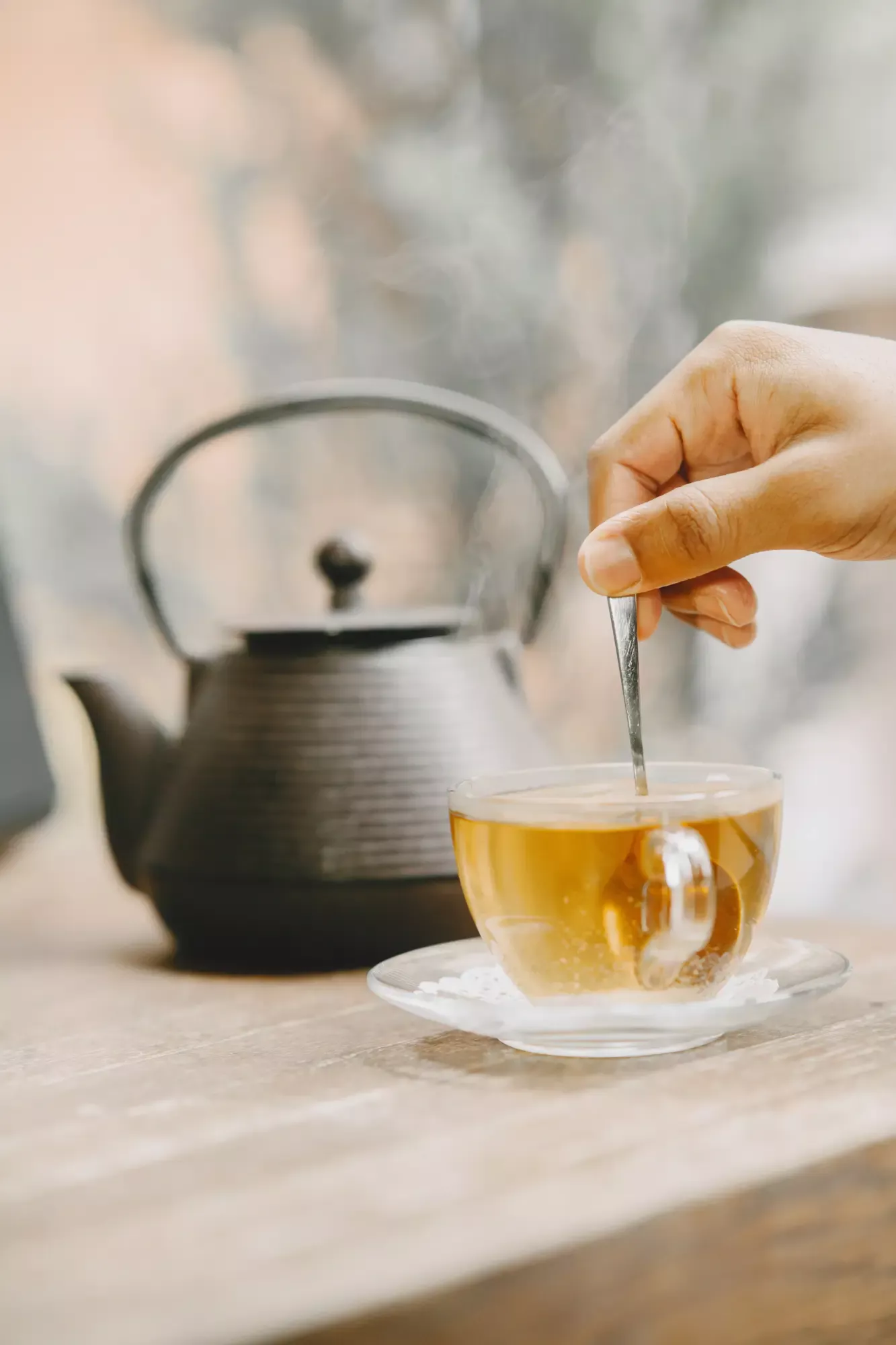 teapot-cup-hot-tea-table-hand-holding-teaspoon